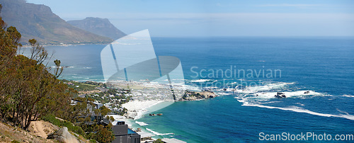 Image of Panorama of a mountain coastline with quiet ocean against a blue sky in South Africa from above. Scenic wallpaper of a serene landscape of calm waves near Camps Bay with a peaceful sea view.