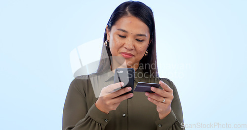 Image of Business, woman or phone in studio with credit card for online shopping or digital payment on blue background. Person, smartphone or technology for fintech banking, investment or sale on mockup space