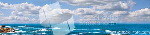Image of Landscape banner of a scenic ocean view in Camps Bay, Cape Town in South Africa. Panoramic scenery of the beach and waves rolling in from the sea against a blue cloudy sky in summer
