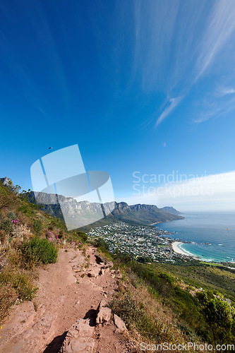 Image of Mountain trails on Lions Head and Table Mountain in a National Park in Cape Town. A scenic view of a walking path in nature next to greenery and plants against a blue sky with copy space in summer