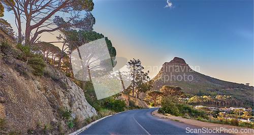 Image of An empty road on the mountain at sunrise. Street overlooking mountain peak with a scenic view of the city from a street on the mountain at sunset. The landscape of a beautiful view of Lions head