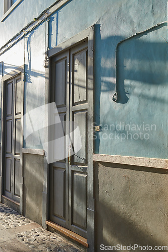 Image of Historic Spanish architecture outdoors of a building in a overseas. Backdoor of a home or residential building. Two old blue doors to a traditional house outside in Santa Cruz de La Palma, Spain.