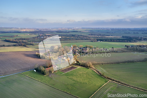 Image of Drone point of view of private farming estate growing rye, wheat and sunflowers in remote farms and fields in Jutland, Denmark. Scenic aerial landscape of agriculture in green and serene countryside