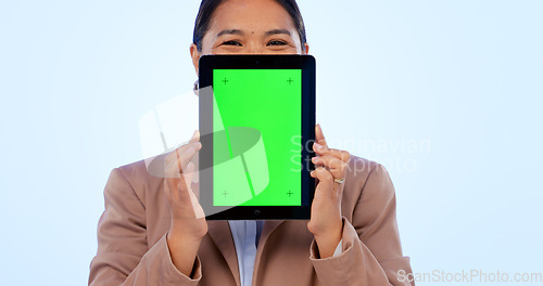 Image of Portrait, tablet and green screen mockup with an asian woman in studio on a blue background for website promotion. Tech, space or chromakey and a person holding a display with tracking markers