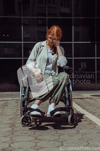 Image of In front of a modern corporate building, a young woman sitting in a wheelchair confidently, symbolizing empowerment, inclusivity, and the strength to overcome challenges in the business world