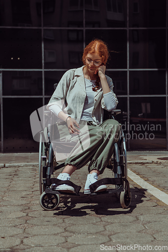 Image of In front of a modern corporate building, a young woman sitting in a wheelchair confidently, symbolizing empowerment, inclusivity, and the strength to overcome challenges in the business world