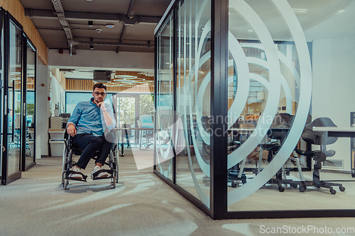 Image of In a large modern corporation, a determined businessman in a wheelchair navigates through a hallway, embodying empowerment and inclusivity in the corporate world.