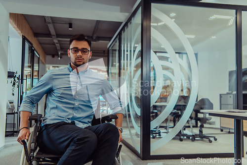 Image of In a large modern corporation, a determined businessman in a wheelchair navigates through a hallway, embodying empowerment and inclusivity in the corporate world.