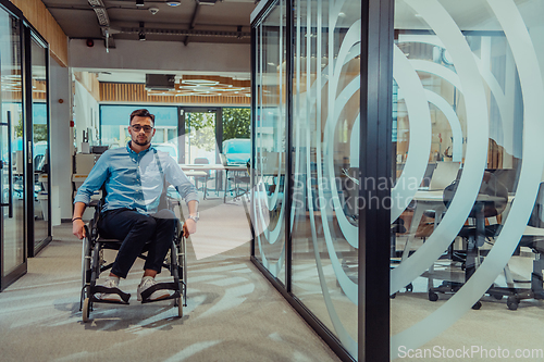 Image of In a large modern corporation, a determined businessman in a wheelchair navigates through a hallway, embodying empowerment and inclusivity in the corporate world.