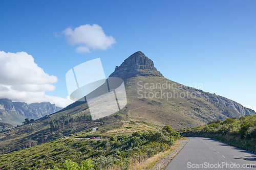 Image of A road leading to Lions Head in Cape Town, South Africa against blue sky copyspace on a sunny morning. A highway along a peaceful mountain landscape with scenic views or lush green bushes and trees