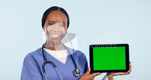 Image of Green screen, doctor and portrait of black woman with tablet for telehealth, wellness and medical news. Healthcare, mockup and person on digital tech for clinic website in studio blue background