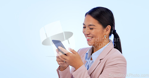 Image of Business, woman and phone in studio for search, networking and planning with happy expression on blue background. Person, smartphone or technology for scrolling on social media or website on mock up