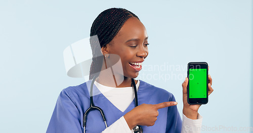 Image of Green screen, doctor and woman with phone pointing for telehealth, wellness app and medical news. Healthcare, mockup and person on smartphone for clinic website, online promo and contact in studio