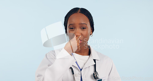 Image of Portrait, black woman and doctor with bad smell in studio isolated on blue background mockup space. Face, intolerable stench and medical professional holding breath, nose and disgust for strong odor