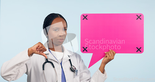 Image of Black woman, doctor and thumbs down with speech bubble for social media or bad review against a studio background. Portrait of African female person, surgeon or nurse showing icon, no sign or mockup