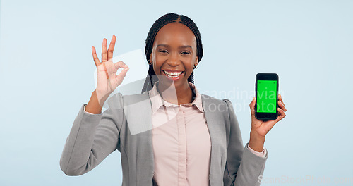 Image of Business woman, ok sign and green screen phone with portrait for review, choice or app by blue background. African entrepreneur, yes and studio for smartphone mockup, chromakey or tracking markers