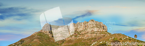 Image of Low angle view of a mountain peak against a stunning colorful sky in South Africa. Scenic panorama landscape of a remote hiking location near Cape Town. Travel and explore nature through adventure