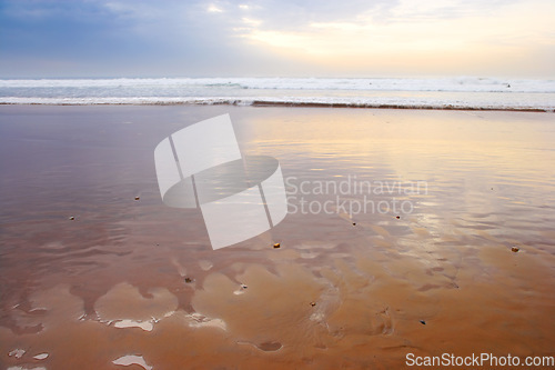 Image of Seascape and landscape of a golden sunset on the west coast of Jutland in Loekken, Denmark. Beautiful cloudscape on an empty beach at dusk. Clouds over the ocean and sea in the evening with copyspace