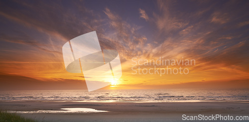 Image of Seascape and landscape of a golden sunset on the west coast of Jutland in Loekken, Denmark. Beautiful cloudscape on an empty beach at dusk. Clouds over the ocean and sea in the evening with copyspace