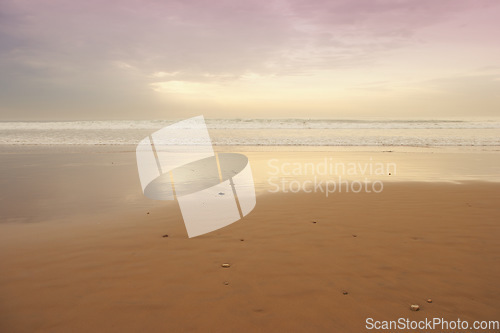 Image of Seascape and landscape of a golden sunset on the west coast of Jutland in Loekken, Denmark. Beautiful cloudscape on an empty beach at dusk. Clouds over the ocean and sea in the evening with copyspace