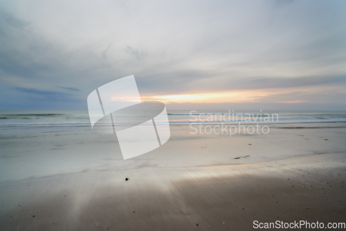 Image of Seascape and landscape of a blue sunset on the west coast of Jutland in Loekken, Denmark. Beautiful cloudscape on an empty beach at dusk. Clouds over the ocean and sea in the evening with copyspace