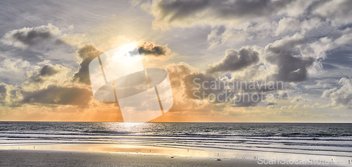 Image of Seascape and landscape of a golden sunset on the west coast of Jutland in Loekken, Denmark. Beautiful cloudscape on an empty beach at dusk. Clouds over the ocean and sea in the morning with copyspace