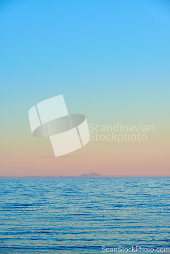 Image of Seascape and landscape of a golden sunset on the west coast of Jutland in Loekken, Denmark. Beautiful view on an empty beach at dusk. Sun rising over the ocean and sea in the morning with copyspace