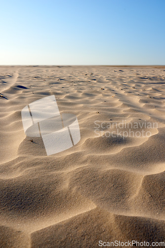 Image of Landscape of sand dunes on west coast of Jutland in Loekken, Denmark. Closeup of sand surface texture on empty desert with blue sky and copyspace. Peaceful calm scenic to explore for travel vacation