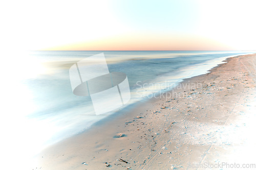 Image of Long exposure of waves washing on empty beach with copyspace at sunset with creative white vignette. Beautiful seascape and landscape at dusk on west coast of Jutland, Loekken, Denmark. Ocean and sea