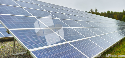 Image of Sun energy. Solar power station in Denmark. Photovoltaic solar cell panels as renewable energy source. Blue solar panels generating electricity in solar power station, alternative energy from nature.