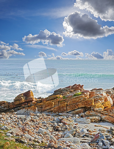 Image of A rocky coastline in the Western Cape, South Africa on a hot summer day. Clear sky and beaches, a perfect getaway filled with self care resorts and wellness outdoor activities with tropical weather