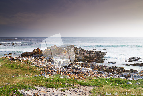 Image of A rocky coastline in the Western Cape, South Africa on a hot summer day. Clear skies and beaches, a perfect getaway filled with self care resorts and wellness outdoor activities with tropical weather