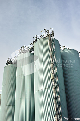 Image of Silo storage tankers against a gray sky in Danish oil industry. large oil plant storage tanks for export in industrial area. Silo tankers for keeping bulk food products, substances and materials safe