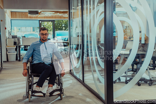 Image of In a large modern corporation, a determined businessman in a wheelchair navigates through a hallway, embodying empowerment and inclusivity in the corporate world.