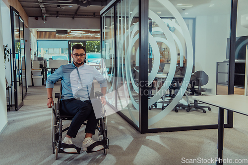 Image of In a large modern corporation, a determined businessman in a wheelchair navigates through a hallway, embodying empowerment and inclusivity in the corporate world.