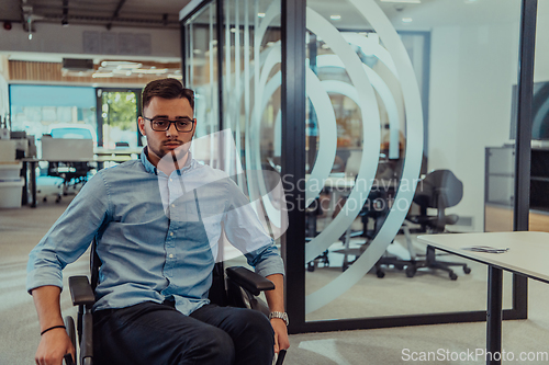 Image of In a large modern corporation, a determined businessman in a wheelchair navigates through a hallway, embodying empowerment and inclusivity in the corporate world.