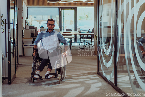 Image of In a large modern corporation, a determined businessman in a wheelchair navigates through a hallway, embodying empowerment and inclusivity in the corporate world.