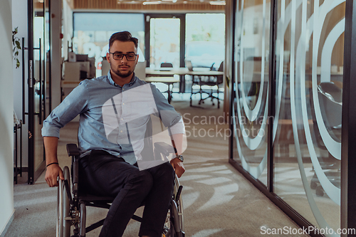 Image of In a large modern corporation, a determined businessman in a wheelchair navigates through a hallway, embodying empowerment and inclusivity in the corporate world.