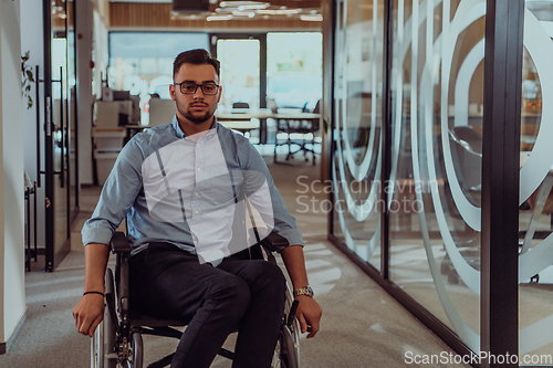 Image of In a large modern corporation, a determined businessman in a wheelchair navigates through a hallway, embodying empowerment and inclusivity in the corporate world.