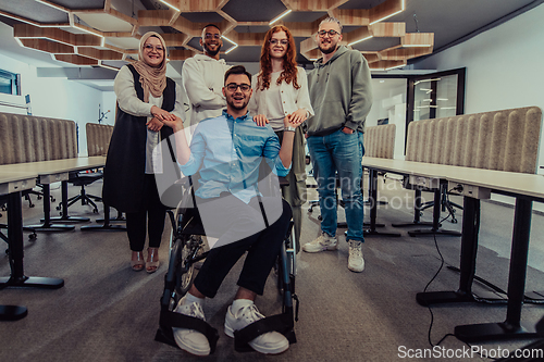 Image of Young businessmen in a modern office extend a handshake to their business colleague in a wheelchair, showcasing inclusivity, support, and unity in the corporate environment.