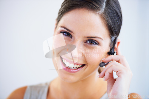 Image of Call center, woman and portrait in studio for communication, telecom questions and customer service support on white background. Face of happy telemarketing consultant with microphone for CRM contact