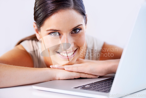 Image of Happy, laptop and business woman in office with positive, good and confident attitude for career. Smile, pride and professional young female creative designer from Canada with computer in workplace.