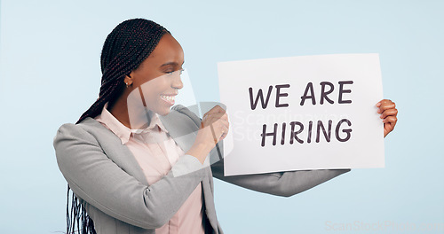 Image of Black woman with we are hiring poster, human resources and opportunity for job on blue background. Recruitment signage, work ads and onboarding for business with sign, offer and management in studio