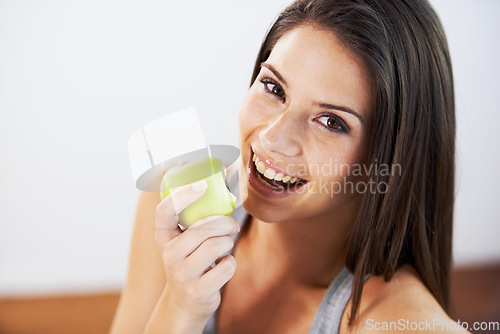 Image of Woman, smile and eating an apple, health and wellness in portrait, nutrition and vitamins for vegan. Female person, fruit and organic or natural, breakfast and diet in outdoors, fresh and digestion