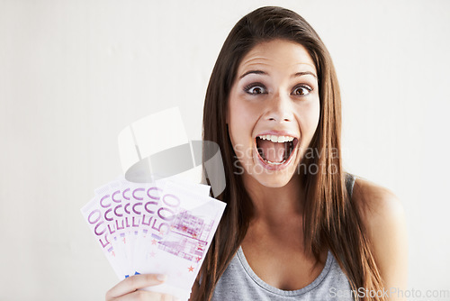 Image of Rich, portrait or woman excited by money success on white background in studio with smile or surprise. Wealthy, wow or happy girl with cash goals, Euros or lottery jackpot for winning a bonus prize