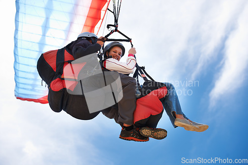 Image of People, paragliding and freedom in sky, together or extreme sport with smile for fitness. Coach, partnership and person on adventure, helmet or fearless with backpack, parachute or flight in portrait