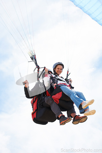 Image of People, paragliding and smile in sky, together or extreme sport with freedom for fitness. Coach, partnership and person on adventure, helmet or fearless with backpack, parachute or portrait in clouds