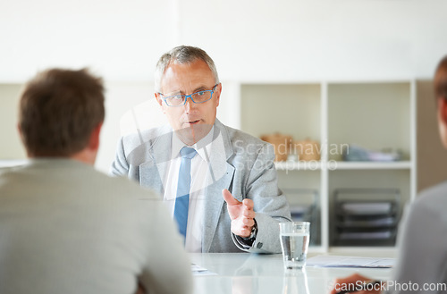 Image of Meeting, people and mature lawyer with advice in office for legal consulting and feedback for clients, Businessman, talking and attorney in negotiation debate and professional advocate in law firm