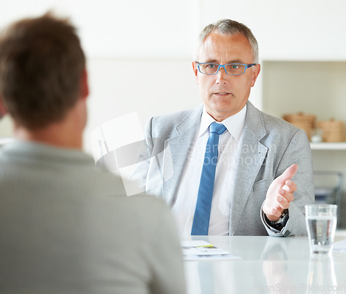 Image of Meeting, businessman and mature lawyer with advice in office for legal consulting and feedback for client. Attorney, talking and advisor in negotiation debate and professional advocate in law firm