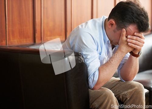 Image of Sad, man and stress on sofa in waiting room with loss of job from mistake or failure. Businessman, crying and sitting on couch with fear of unemployment, anxiety or frustrated with problem at work